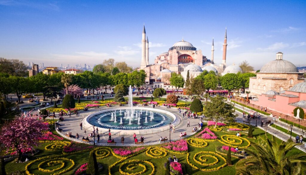 Aerial view of the iconic Hagia Sophia in Istanbul, Turkey, showcasing its majestic domes, minarets, and surrounding urban landscape.