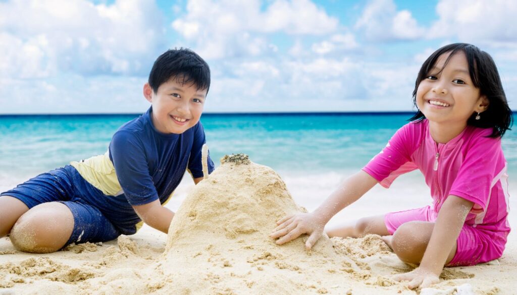 Children building sandcastles at the beach or exploring a city.